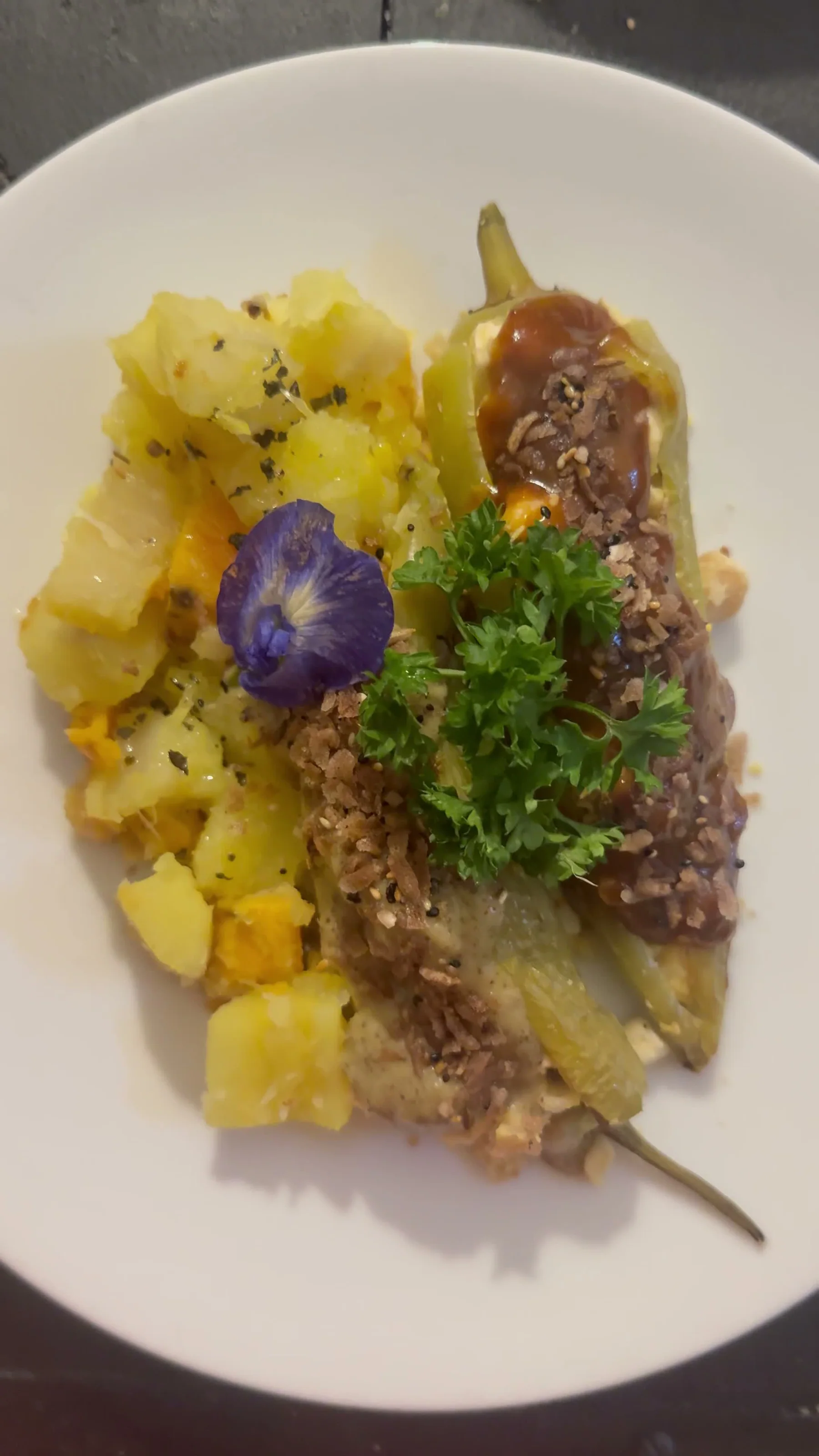 Finished stuffed pepper with potatoes, herbs and edible flowers