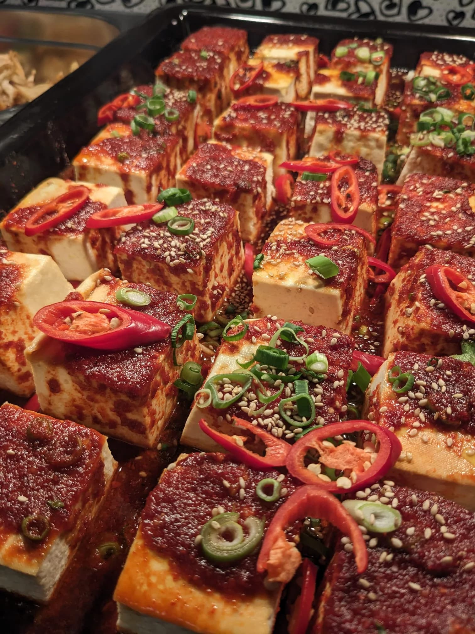 Gochujang tofu finished with sesame and spring onion