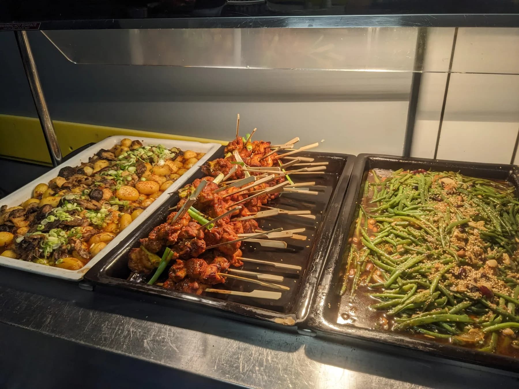 Chicken skewers, vegetables and potatoes prepared for Korean artist catering
